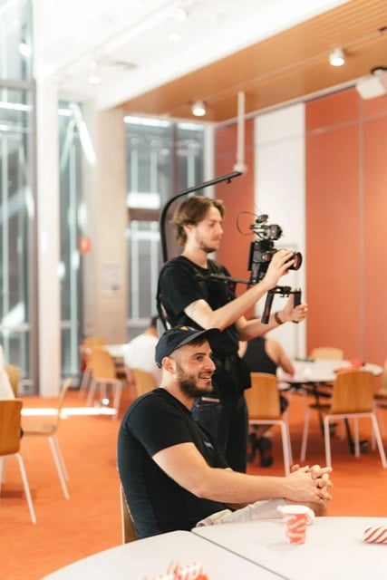 Two Viewix crew filming an interview in a modern office
