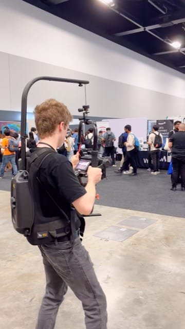 Viewix operator with a gimbal rig at a trade expo